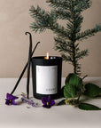 Cèdre Scented Candle with a violet, vanilla, and some plants
