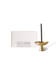 Box of 30 black copal incense sticks with a single incense burning in a brass incense holder