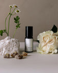 bonne nuit aromatherapy roller with stone, resins, white flower, and stone