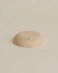 underside of travertine incense holder plate, highlighting the stone's texture and finish