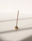brass ellipse shaped incense holder with Japanese incense