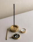 Different parts of the burner showing its versatility; incense sticks on the base and resins on a net-hold holder