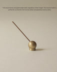 brass sphere incense holder with floral Japanese incense stick