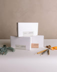 Three boxes of Burning Ritual incense—White Sage, Black Copal, and Palo Santo—with botanical elements and three sample incense sticks