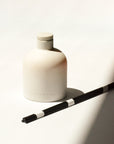 Home fragrance diffuser bottle accompanied by 5 reed sticks for a calming aromatic experience