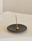 brass incense holder with Japanese Incense stick on the clay incense plate and wellness journal