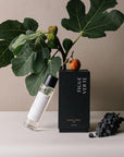 Figue Verte Room Spray with a package, fig, grapes, and some plants
