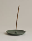 green ceramic incense holder plate with cinnamon incense stick