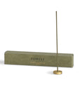 hinoki incense with a brass holder and packaging box behind