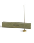 hinoki incense with a brass holder and packaging box behind