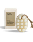 Hinoki Shea butter sacred bar soap with packaging behind
