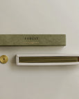 hinoki incense sticks on the built-in insert and brass holder on the side