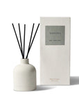 mantra reed diffuser with sticks in a ceramic jar and the packaging box behind