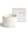 mantra wellness candle with packaging box behind