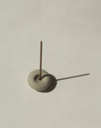 mini grey ceramic pebble incense holder with incense stick