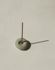 mini grey ceramic pebble incense holder with incense stick