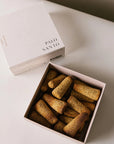 Open box of 20 Palo Santo incense cones made from natural ingredients, used for purification and grounding rituals