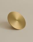 The front view of a brass incense holder, showcasing its elegant design and polished finish