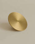 The front view of a brass incense holder, showcasing its elegant design and polished finish