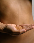 Organic body wash gel poured into hand, showing clear texture and gentle cleansing formula.