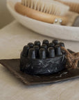 palo santo charcoal bar soap with a plate in the bathroom