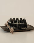 palo santo charcoal bar soap with a ceramic plate