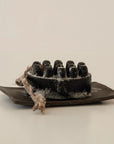 palo santo charcoal bar soap with a ceramic plate