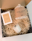 palo santo bath flakes, palo santo bar soap, and mantra mini candle displayed with a gift box, ideal for a thoughtful gift set