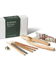 Sacred Burning Ritual kit featuring Palo Santo sticks, white sage bundle, mini incense sticks, and a small brass holder