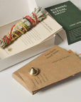Burning Ritual kit with white sage bundle, Palo Santo wood sticks, incense sticks, brass incense holder, and instruction cards