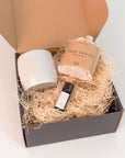 Palo Santo bath flakes, ceramic oil burner, and Palo Santo essential oil arranged with a gift box, creating a calming and aromatic gift set