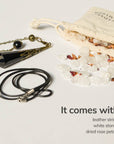 pendulum comes with leather string, white stones, and dried rose petals.