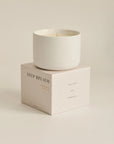 Candle with packaging labeled 'DEEP BREATH'