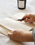 wellness journal with pen and candle