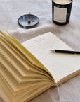 wellness journal with pen, incense and candle