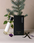 Cedre Room Spray with a package, flower, and some plants