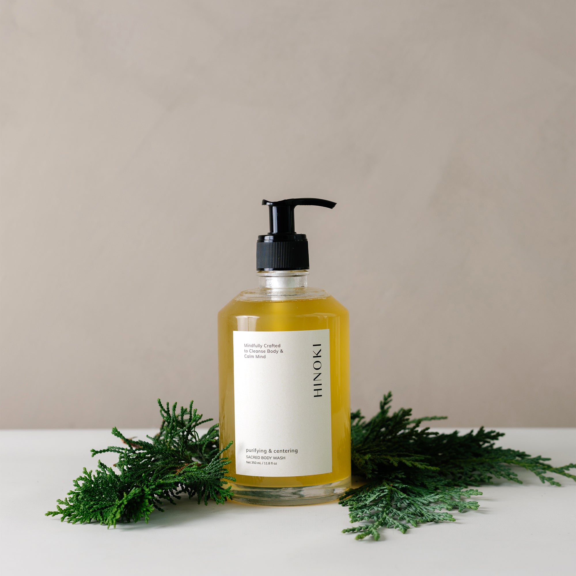Japanese Cypress Hinoki Body Wash in a glass pump jar