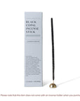 Black copal hand rolled incense stick with incense holder and package on the side.