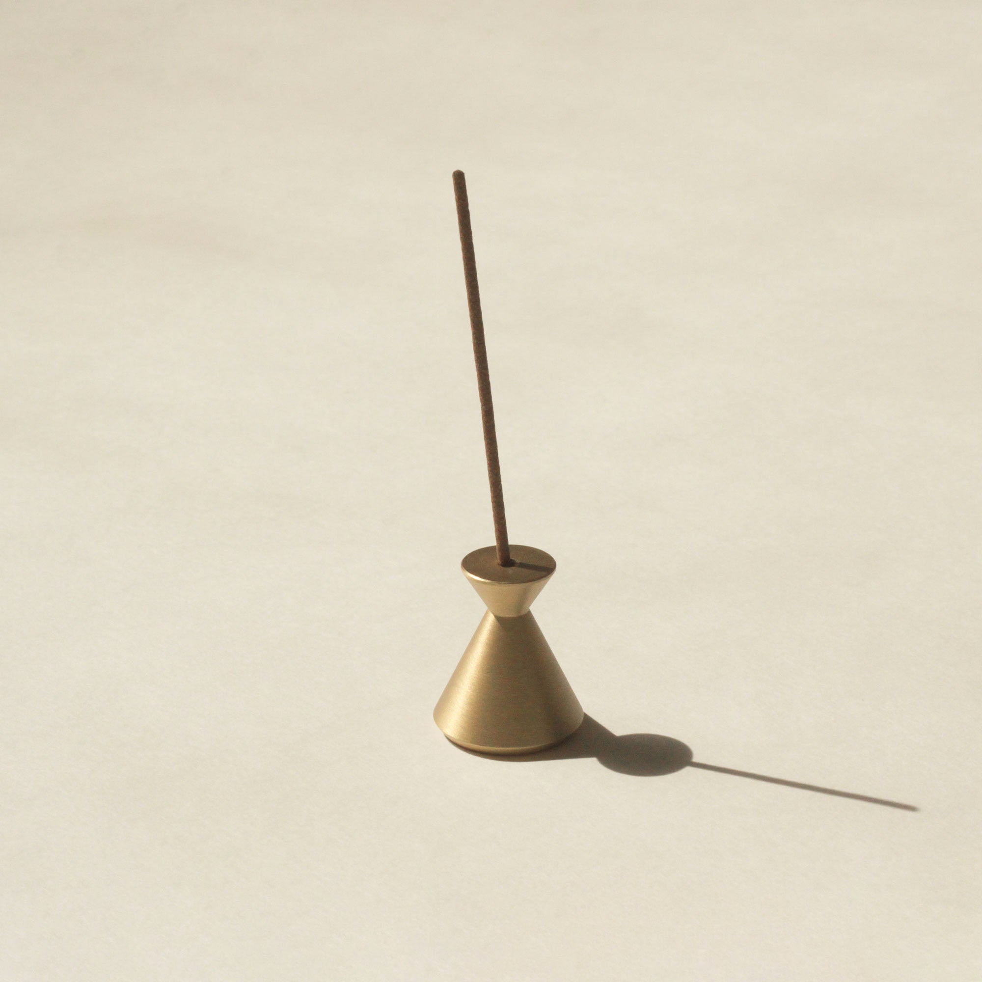 brass hourglass incense holder with Japanese incense stick