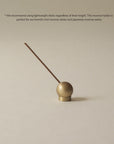 brass sphere incense holder with floral Japanese incense stick