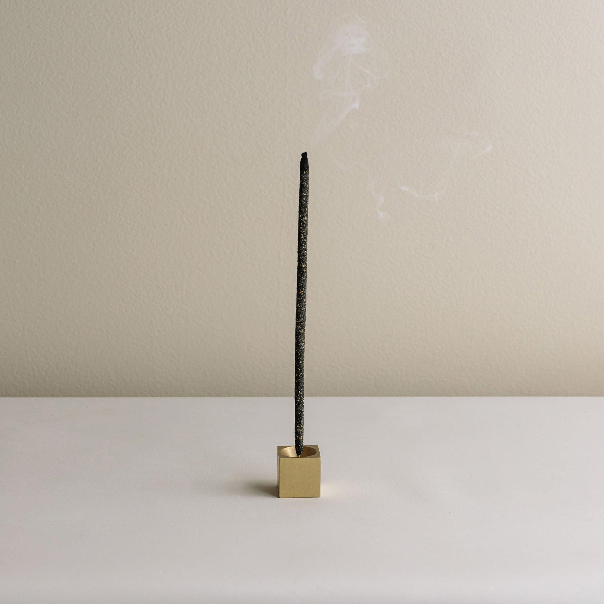 burning incense stick with cubic incense holder 