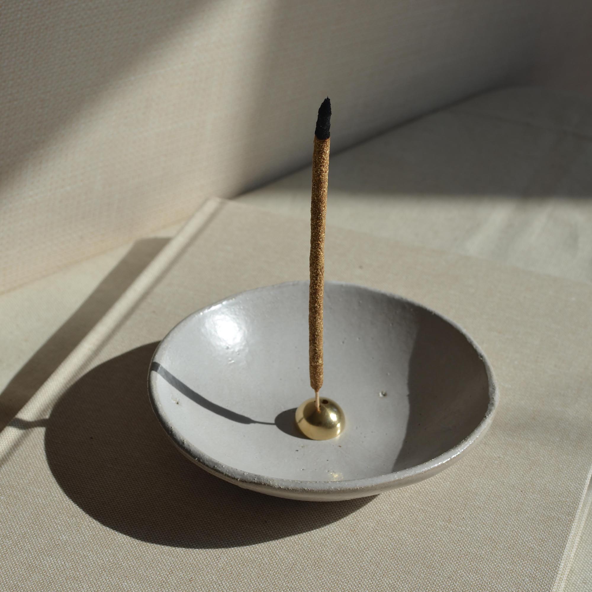 incense stick with incense holder with a brass placing on the incense bowl
