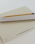 Burning stick incense in minimal aluminum incense holder styled in modern home setting