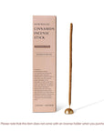 Cinnamon hand rolled incense stick with incense holder and package on the side.