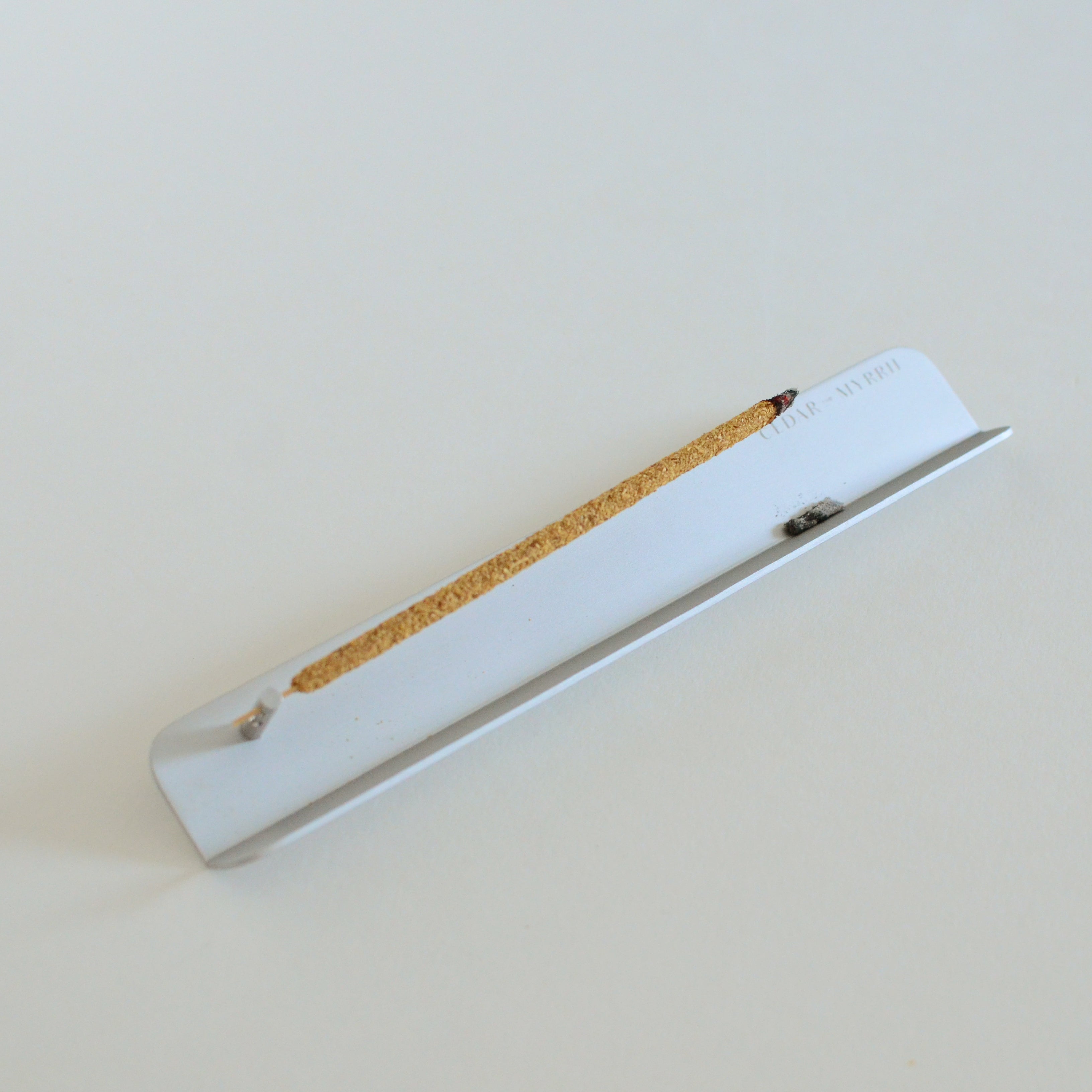 Aluminum incense holder designed for clean ash fall with burning stick incense