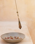 smoky quartz crystal pendulum with a ceramic smudging bowl 