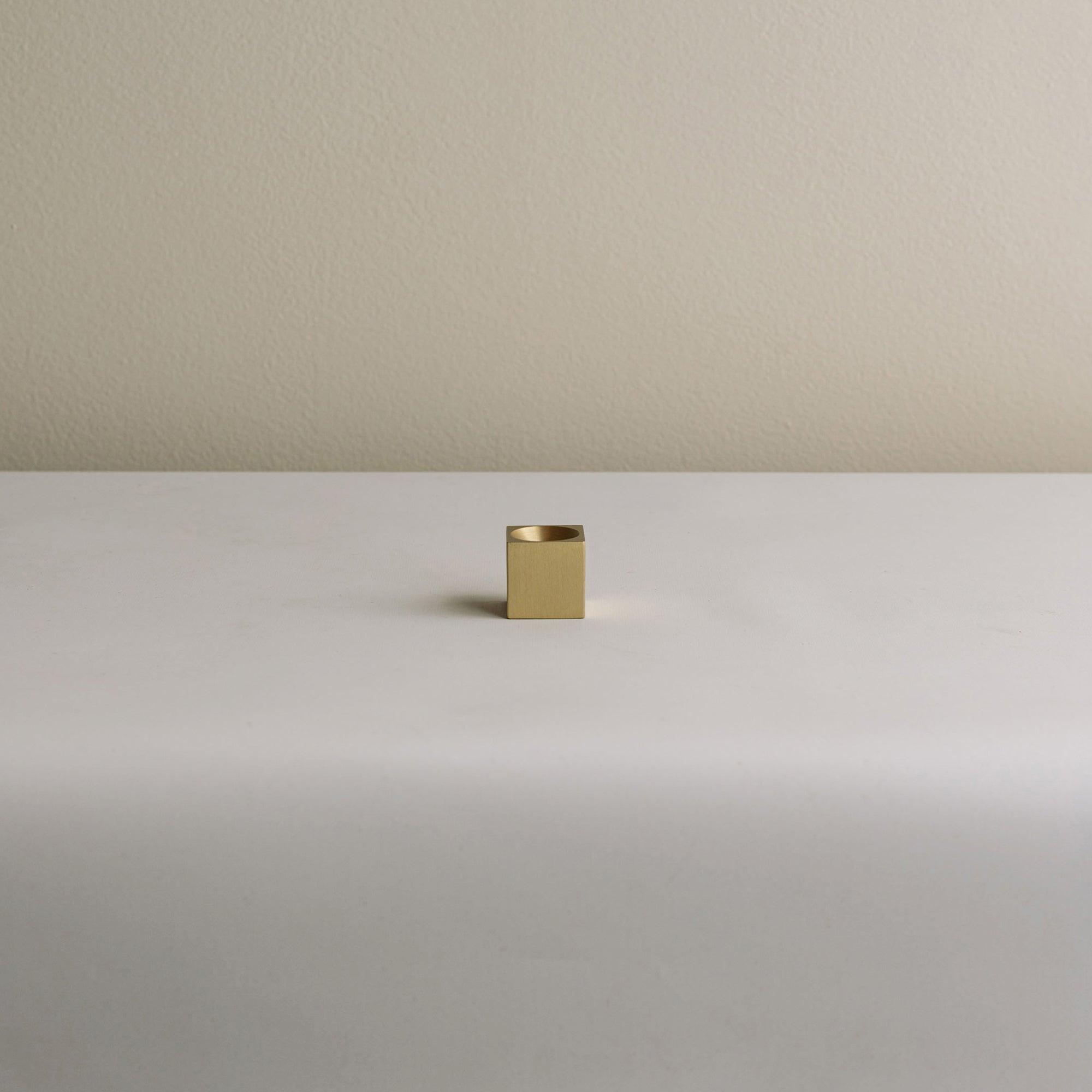 incense holder with a cubic shape and a brass