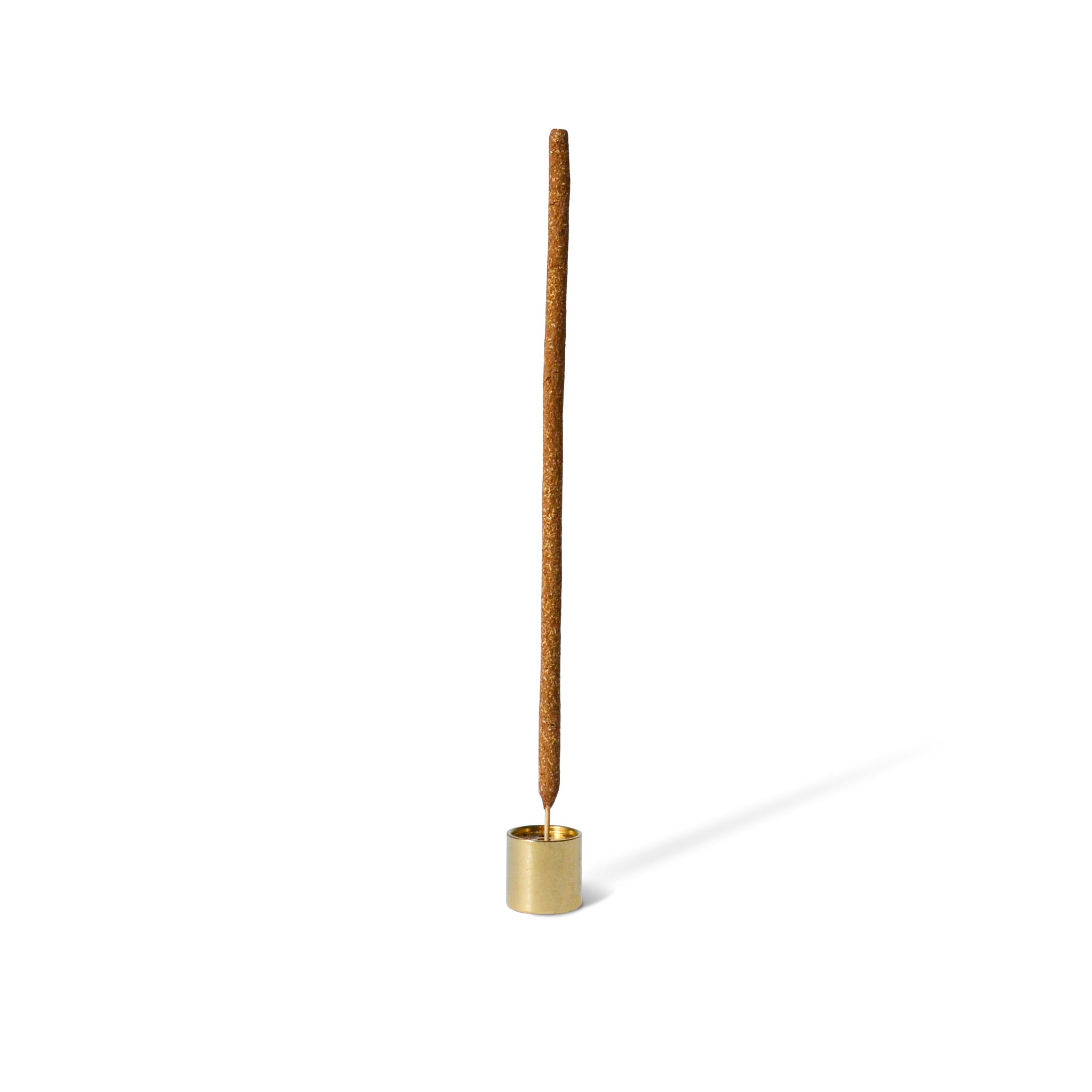 cinnamon incense with a cylinder incense holder with a brass