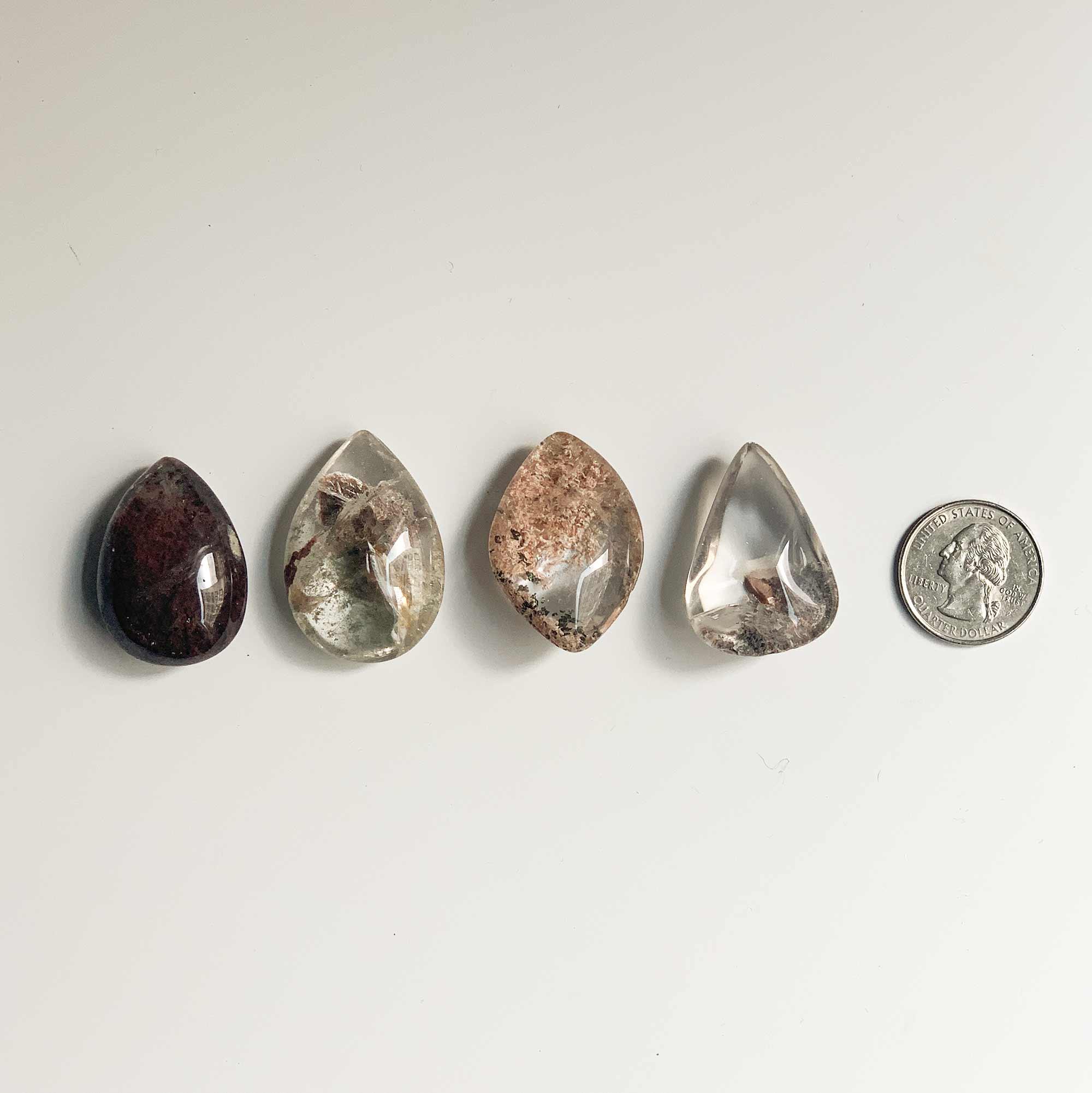 4 different shapes and colors of garden quartz and quarter coin