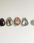 4 different shapes and colors of garden quartz and quarter coin